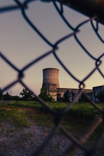 a fenced off area with a building in the background