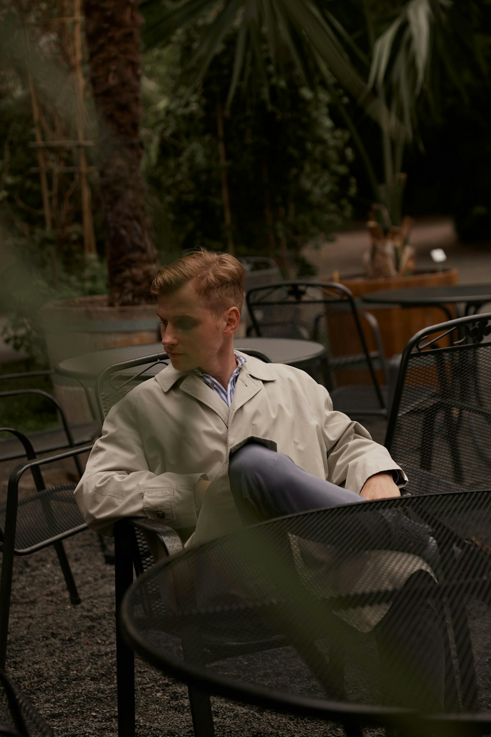 a man sitting in a chair outside