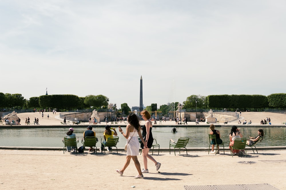 a couple of women walking on a beach