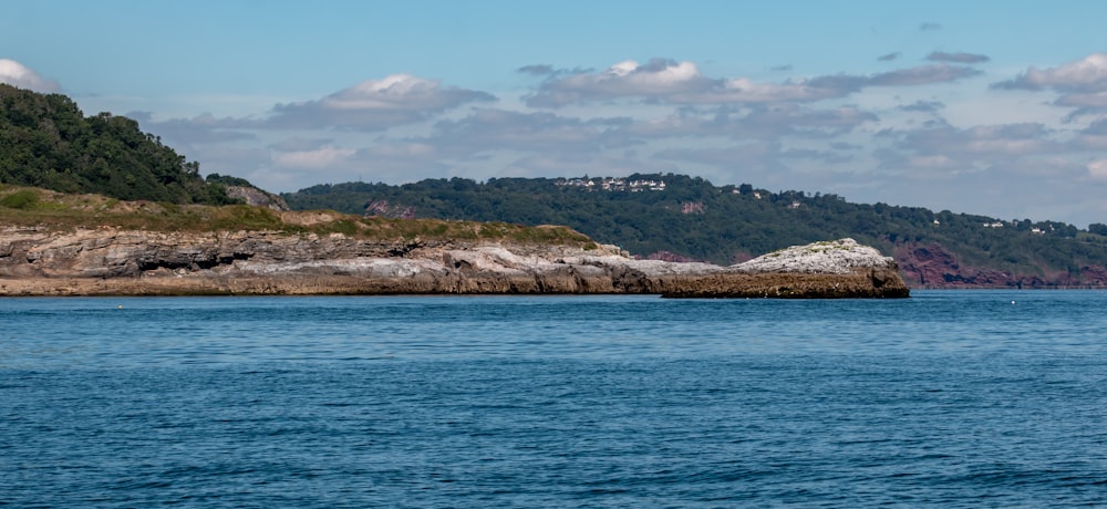 a body of water with land in the back