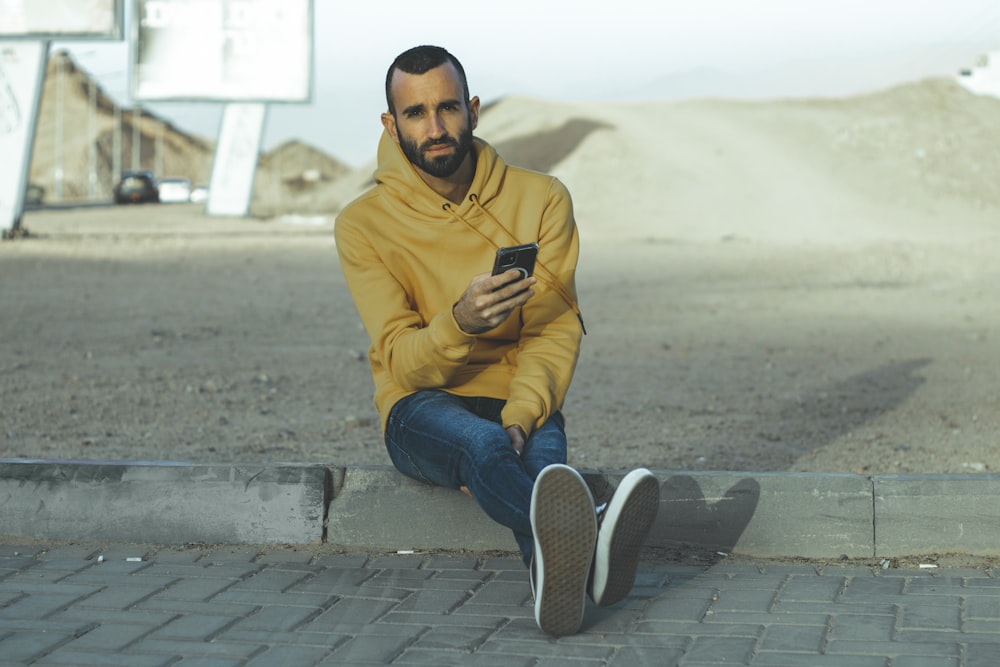 a man sitting on a curb