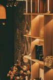A close-up of stylish home decor items arranged on a shelf with warm natural light.