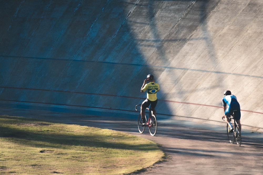 a group of people riding bikes on a road