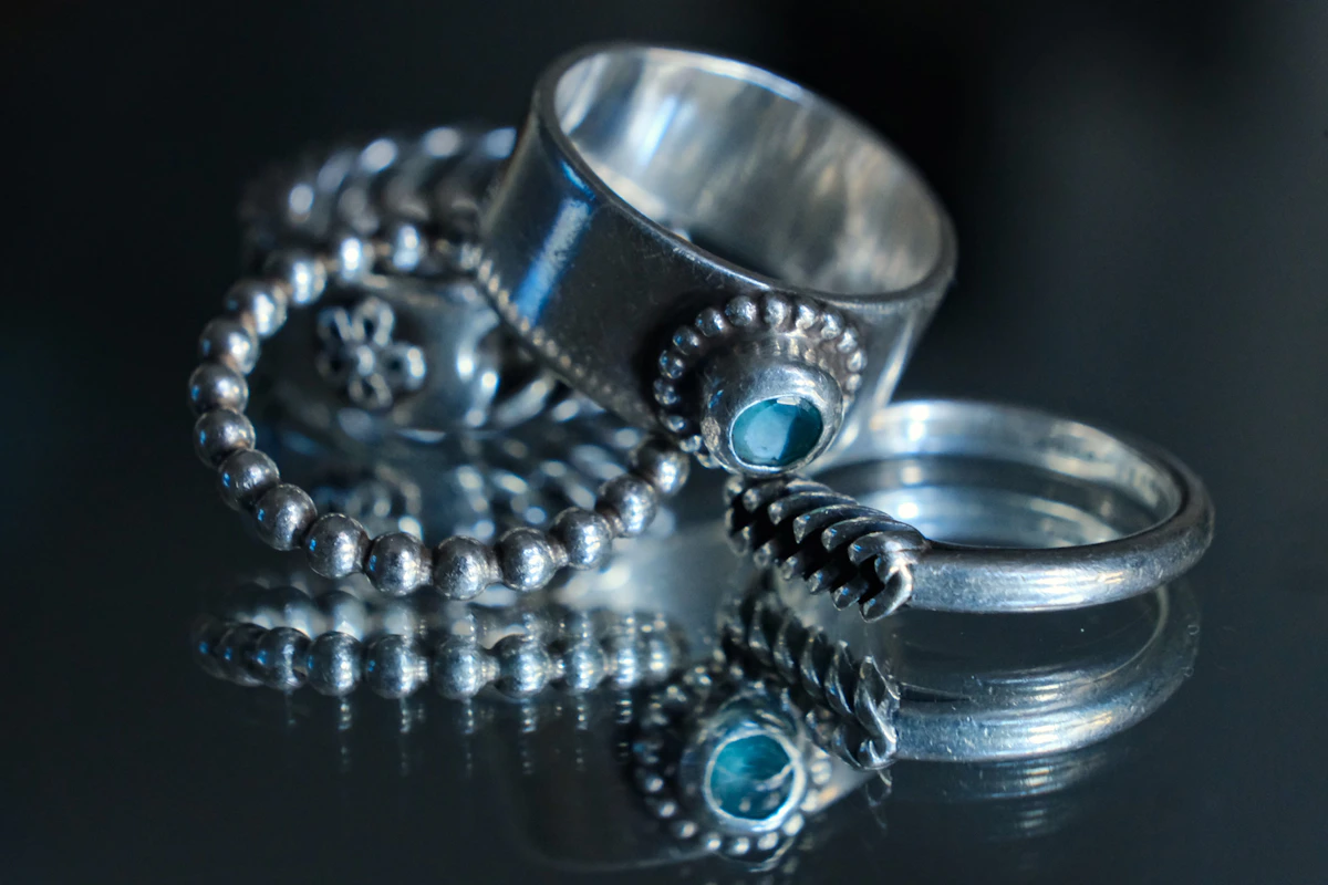 Handmade sterling silver jewellery pieces arranged on a neutral background