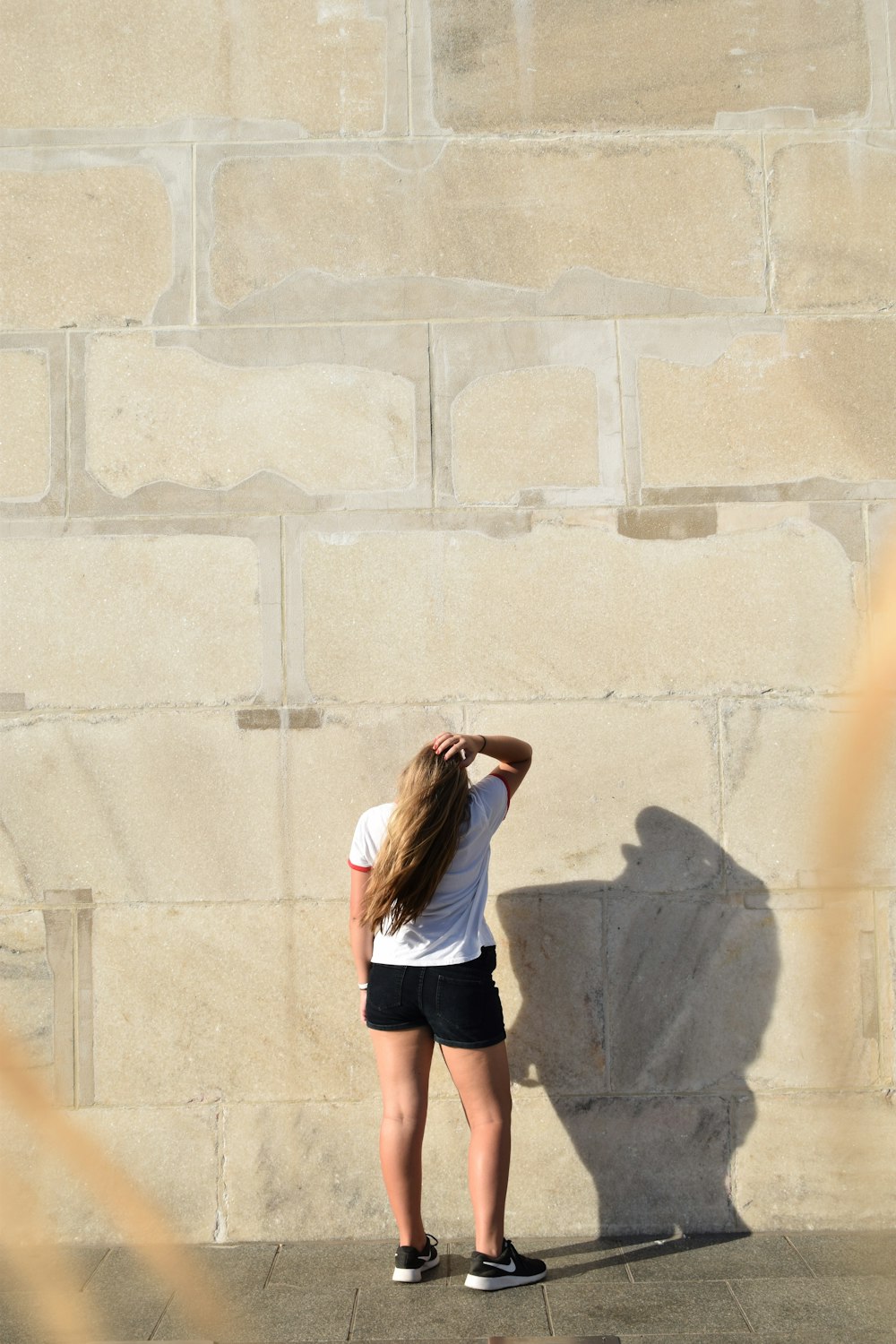 a person leaning against a wall