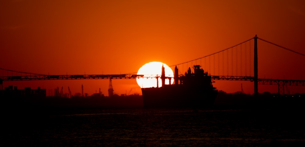 a bridge with a sunset in the background