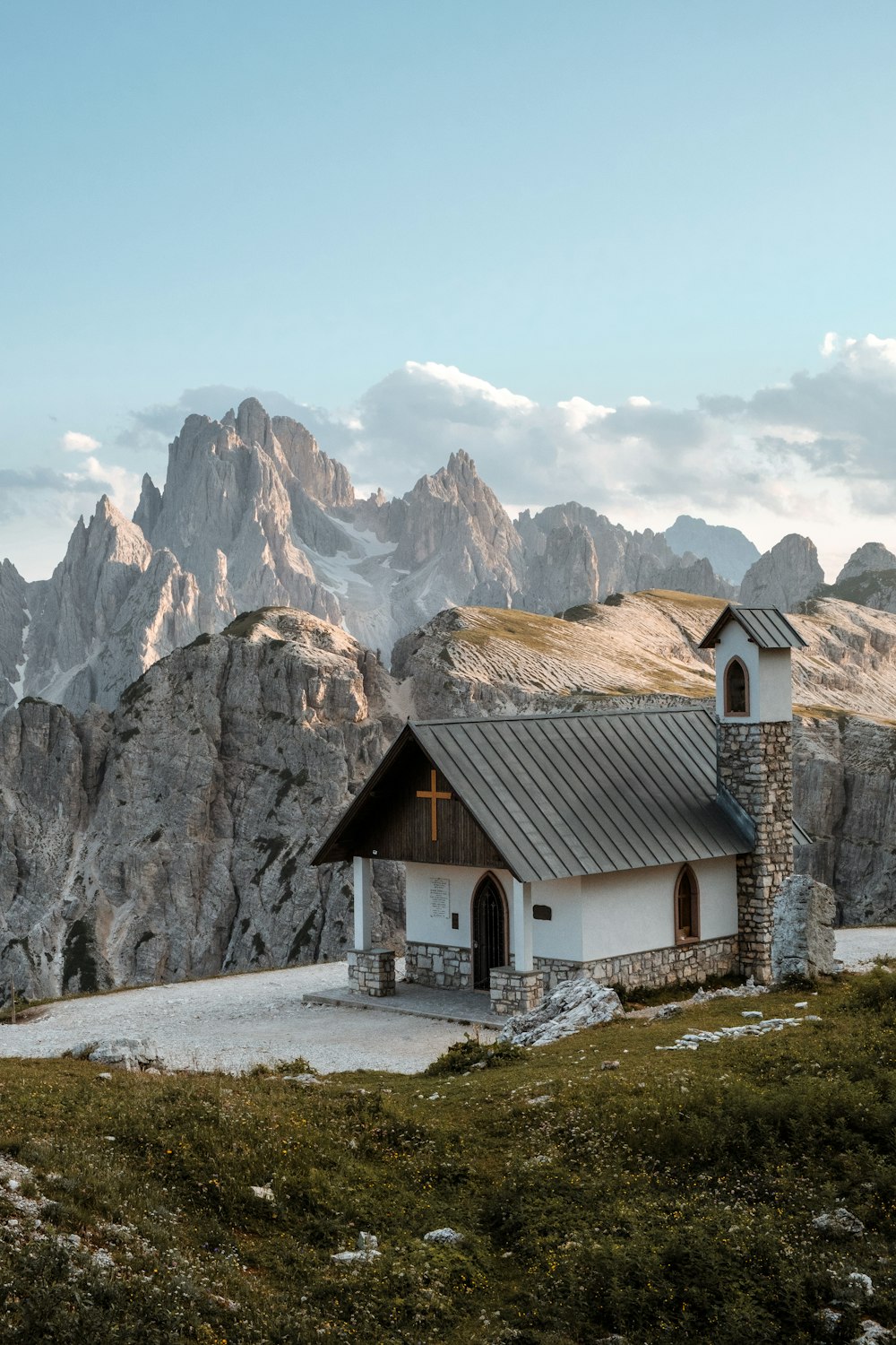 a white building with a mountain in the background