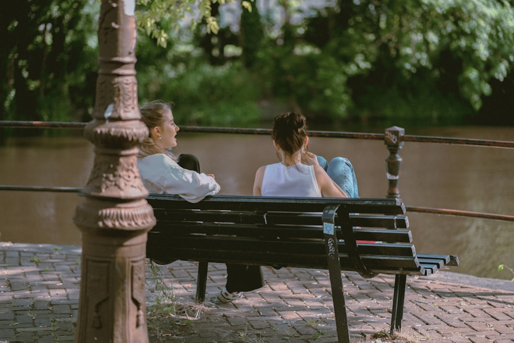 two women sitting on a bench