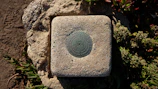 Outdoor site with markers indicating geomantic survey points.