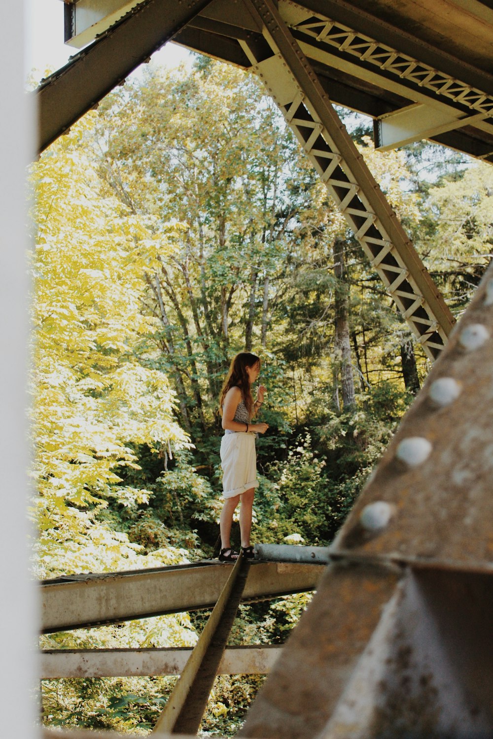 a person standing on a wooden bridge