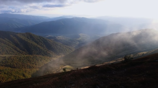 A panoramic view of the Smoky Mountains with morning fog rolling over the ridges.