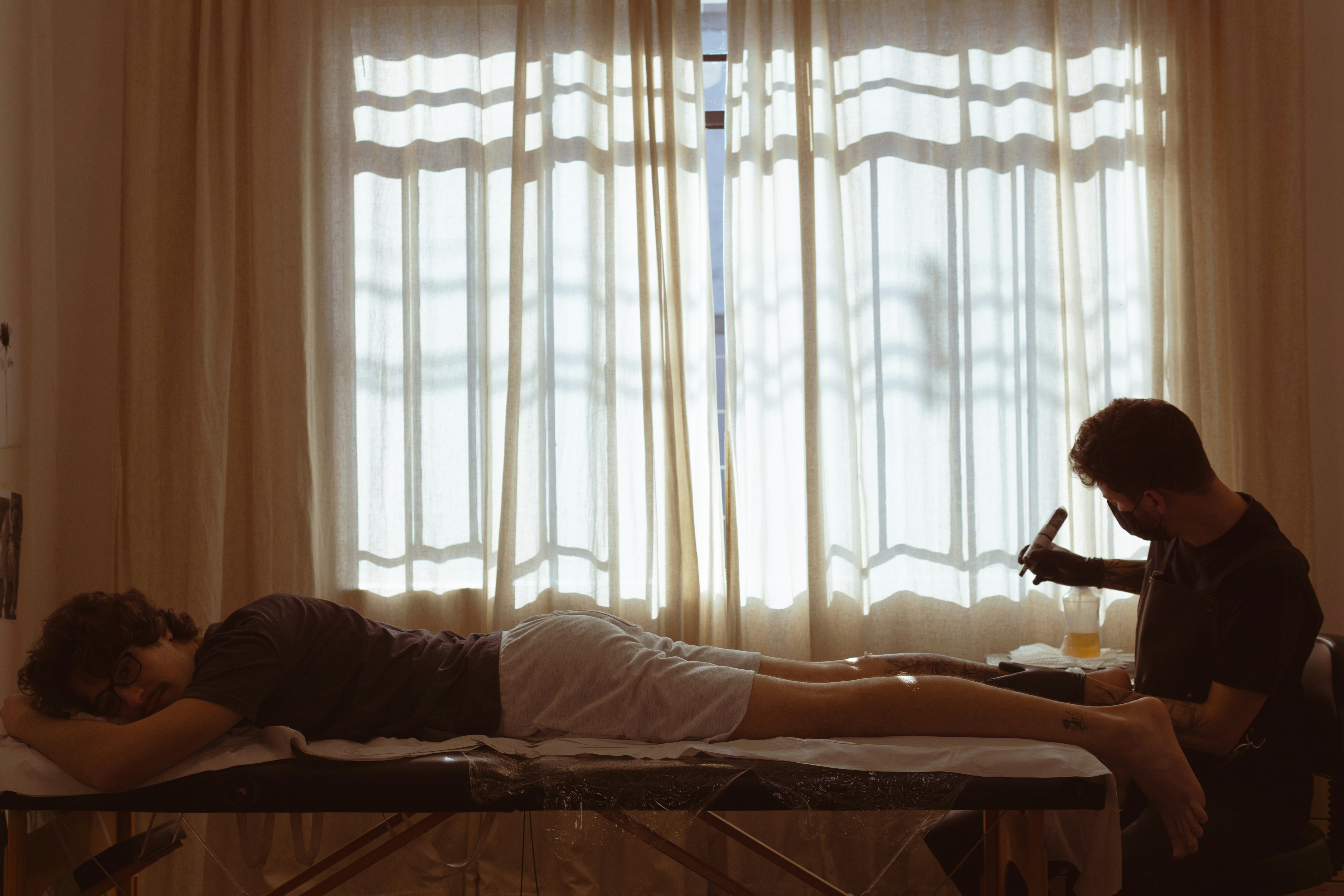 a man lying on a bed with a woman lying on the bed