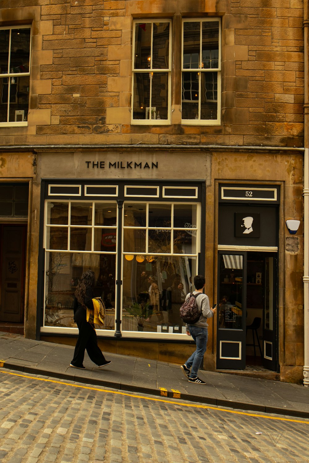 people walking past a store