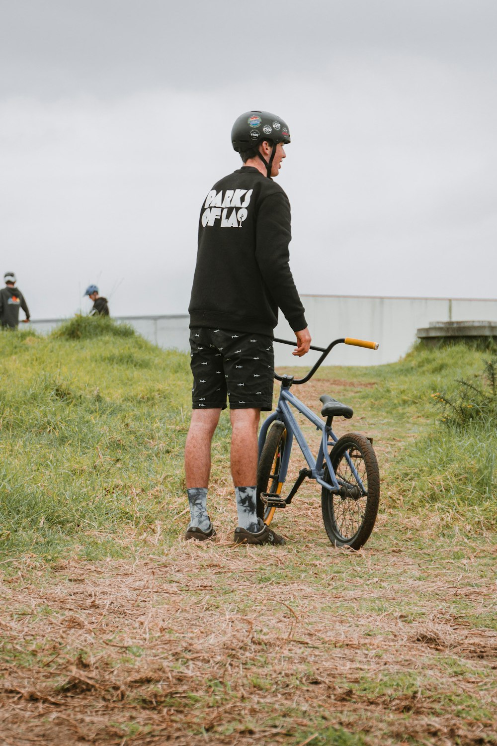 a man standing next to a bicycle