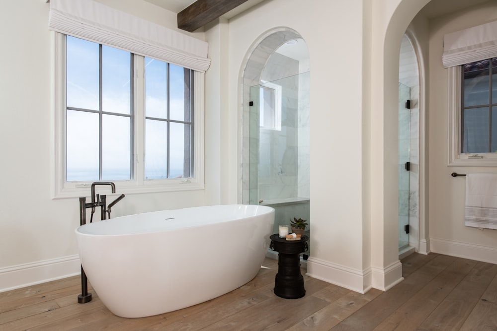 a bathroom with a tub and a large mirror