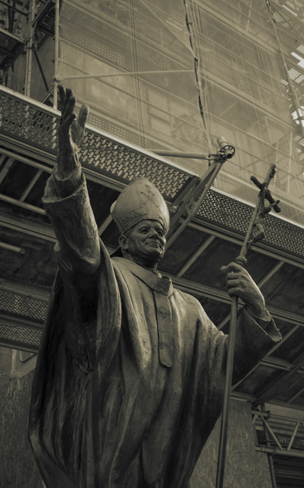 a statue of a man holding a cross