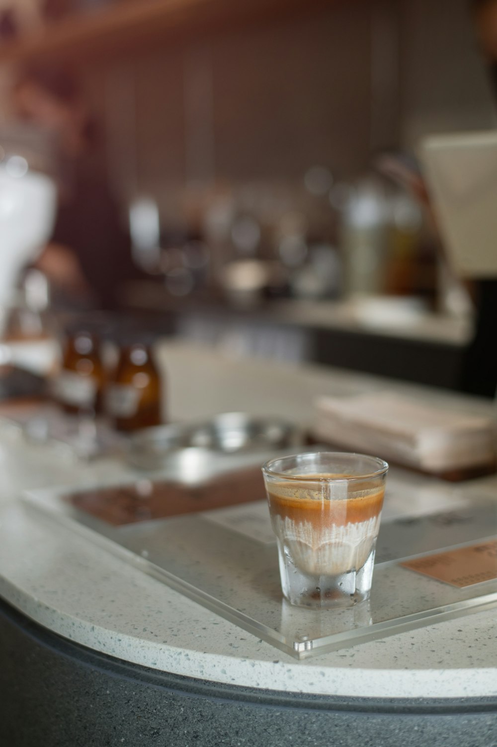 a glass of liquid on a table