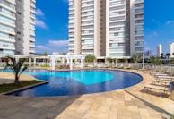 a pool in a courtyard with tall buildings in the background