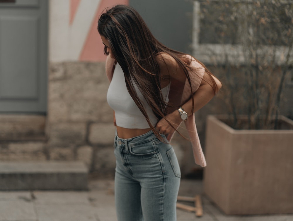 a woman leaning against a wall