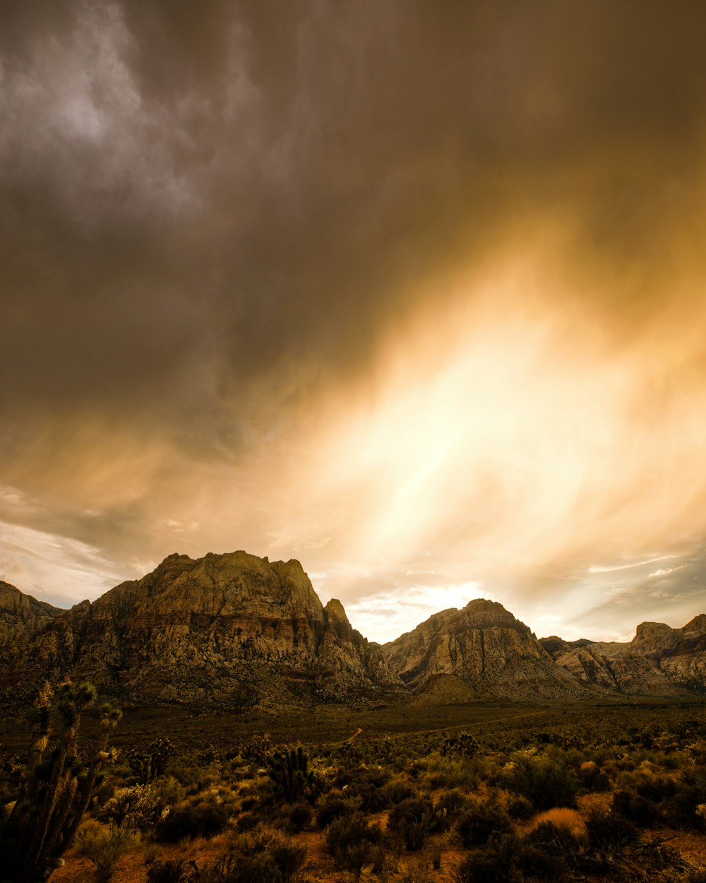 a landscape with mountains and clouds