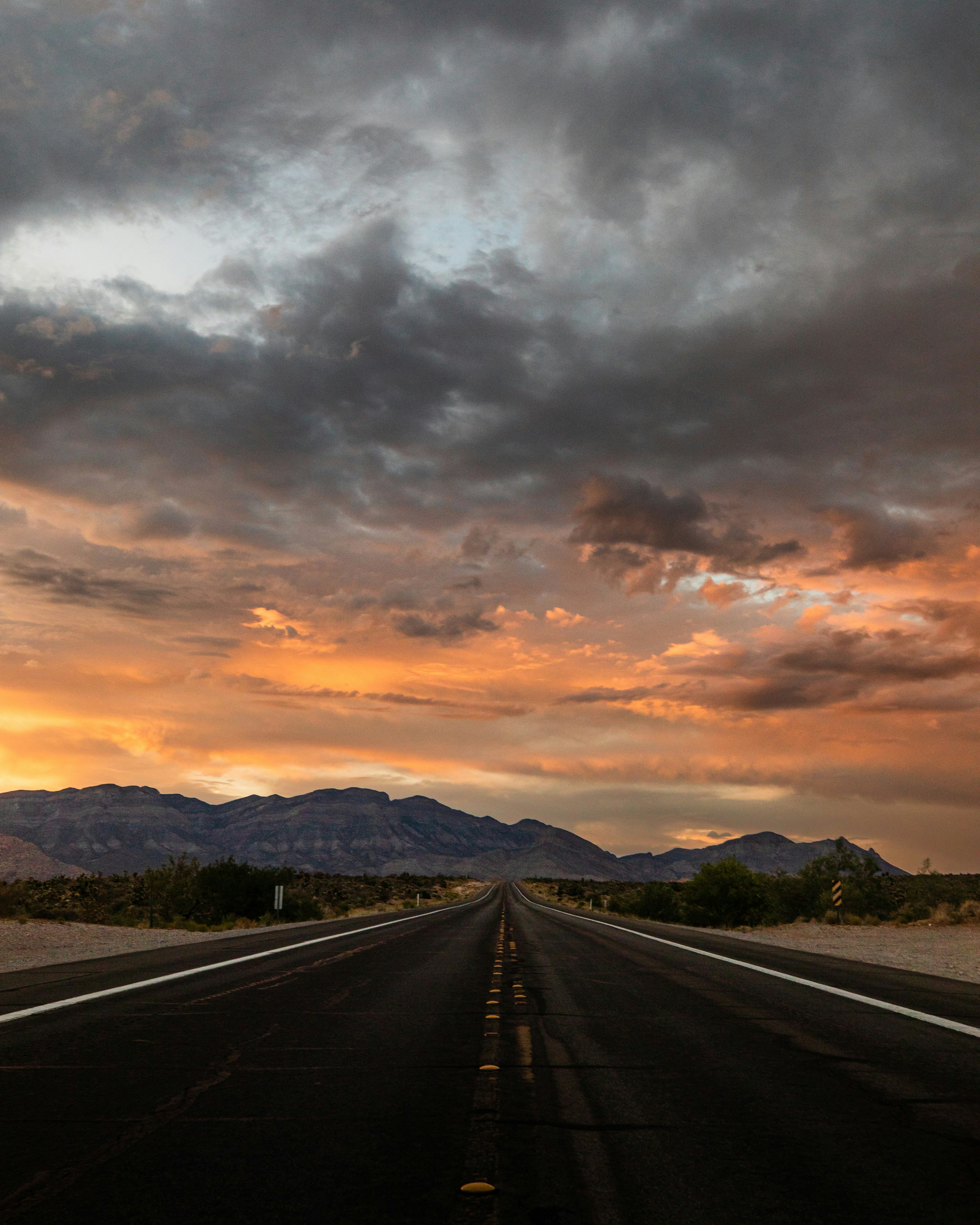 a road with mountains in the background