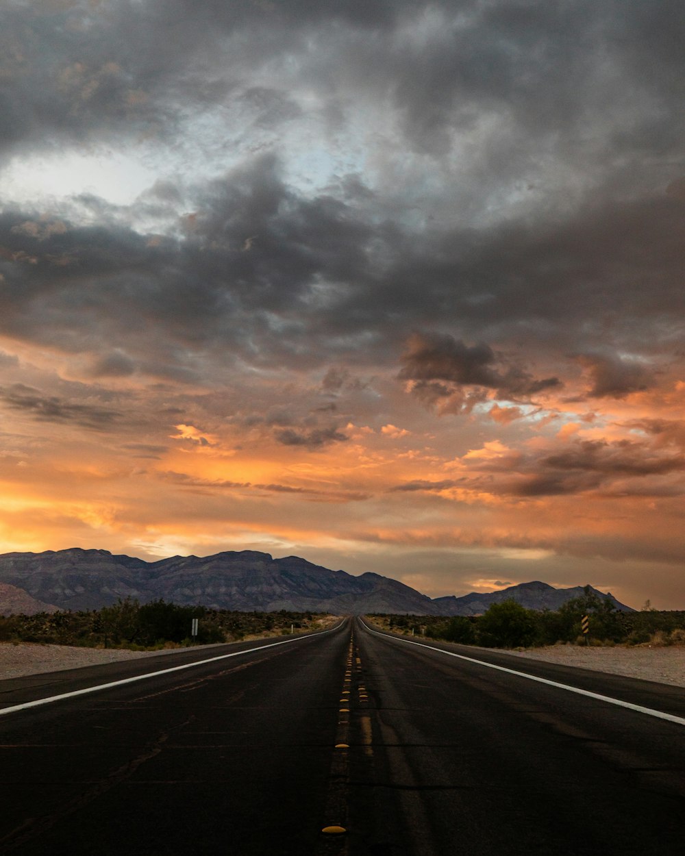 a road with mountains in the background