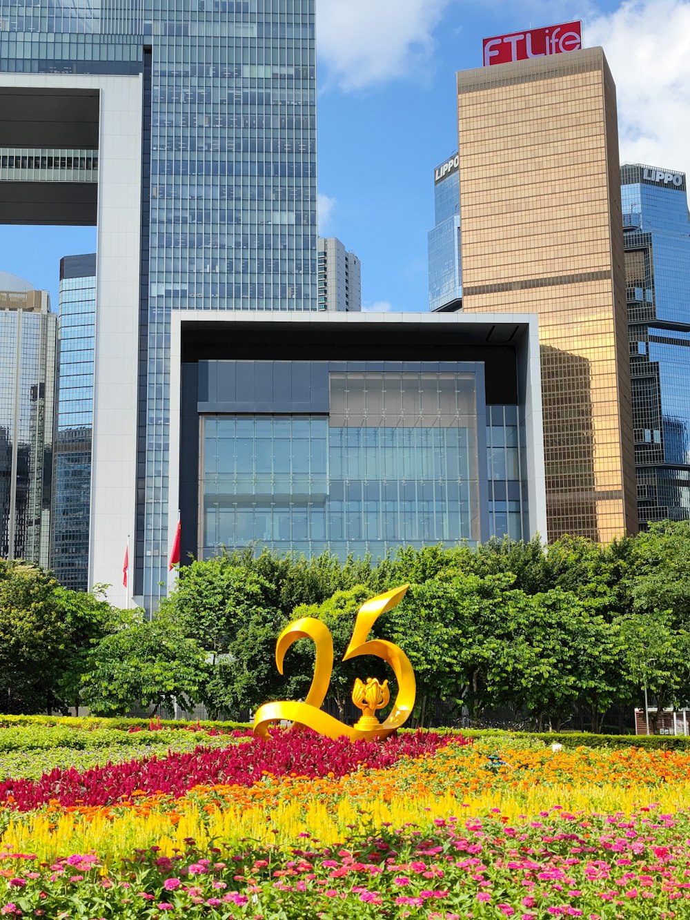 a large flower bed in front of a city