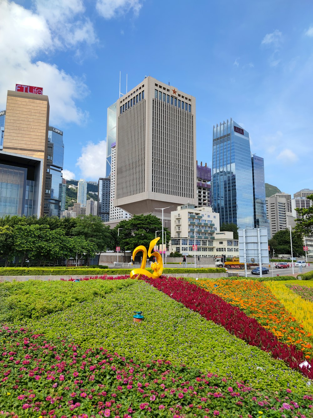 a large flower bed in front of a city