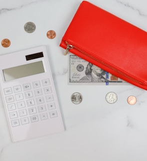 a red wallet and coins