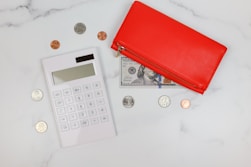 a red wallet and coins