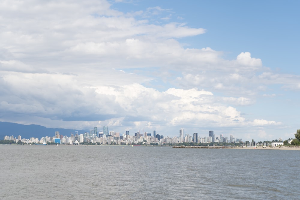 a body of water with a city in the background