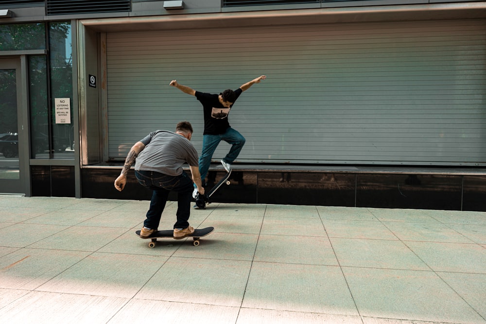 a couple of men riding skateboards