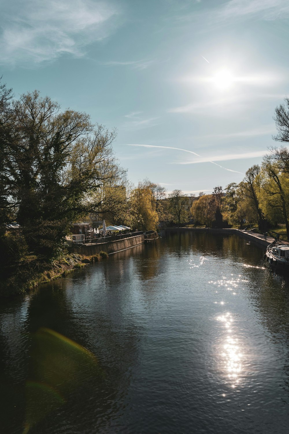 a river with trees and a dock