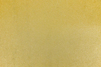 A fine textured surface with a uniform metallic gold finish