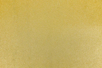 A fine textured surface with a uniform metallic gold finish