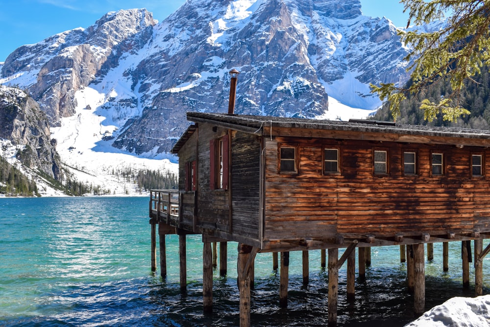 a cabin on a dock over water