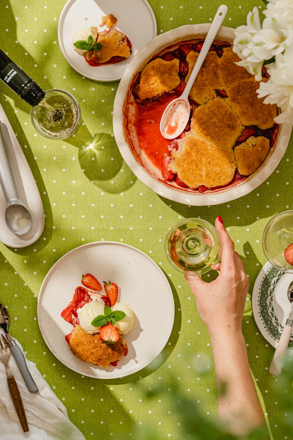 a person holding a spoon over a plate of food