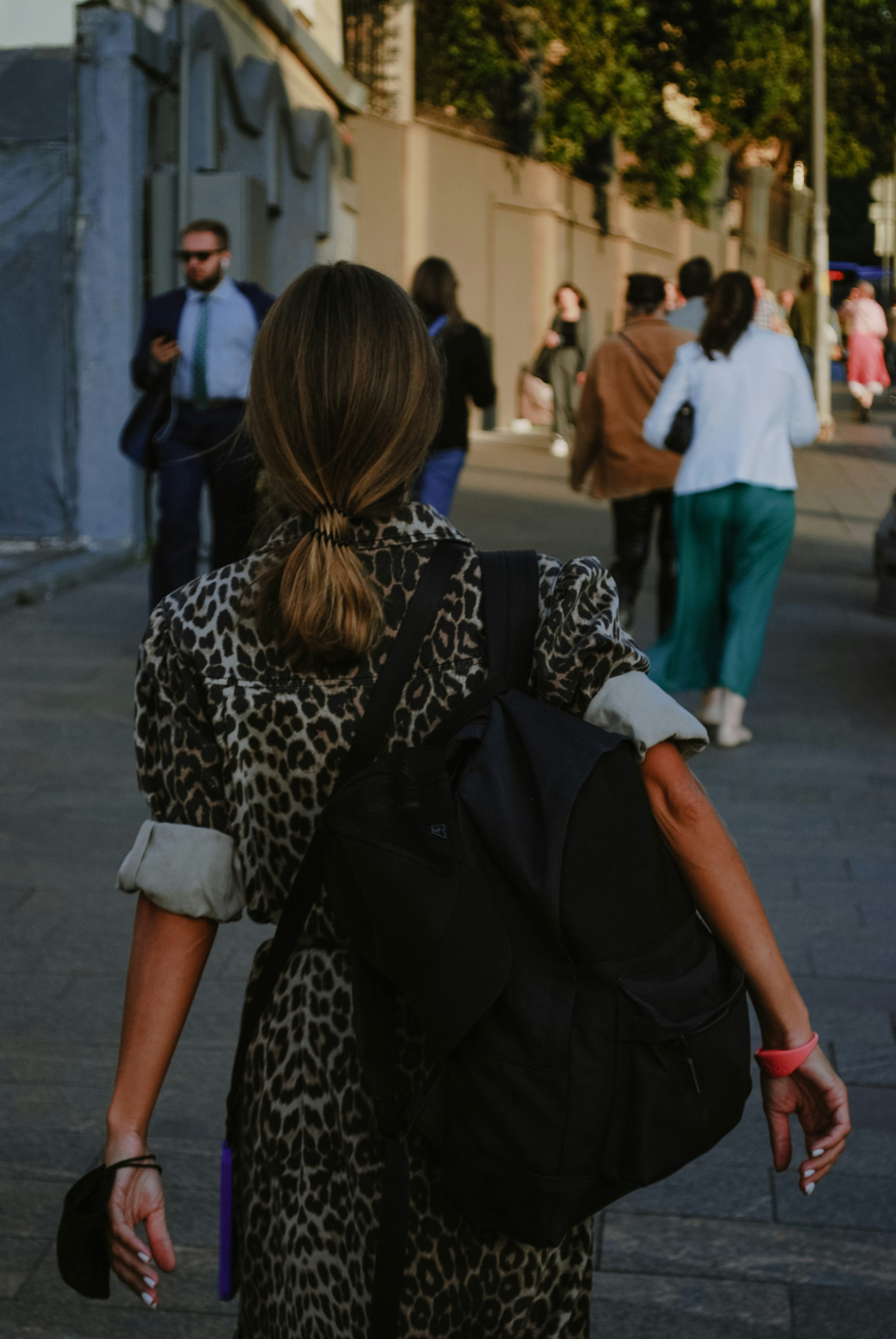 a couple of women walking down a sidewalk