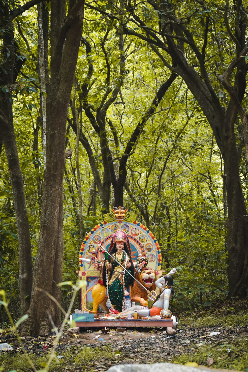 a group of people sitting on a colorful structure in the woods