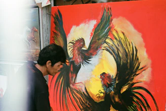 a man and woman looking at a painting on a wall