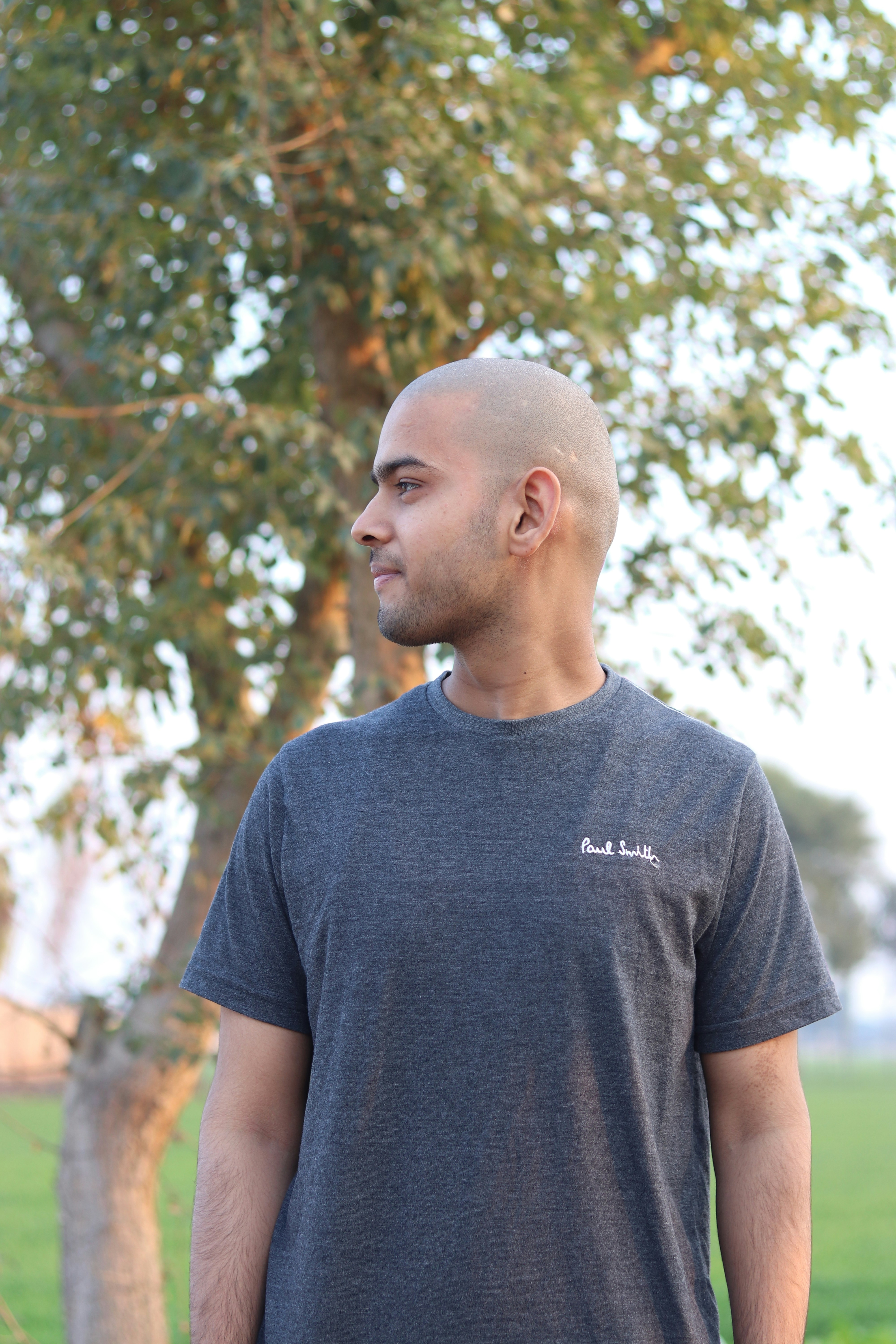 a man standing in front of a tree