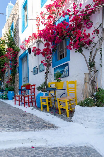 a table and chairs outside a house in Greece