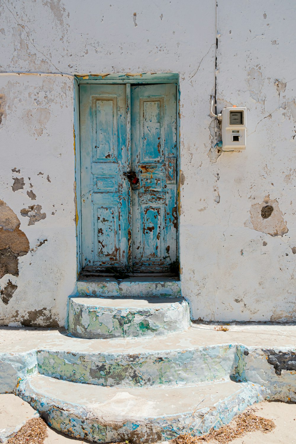 a blue door on a white wall