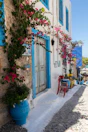 a building with blue doors and flowers