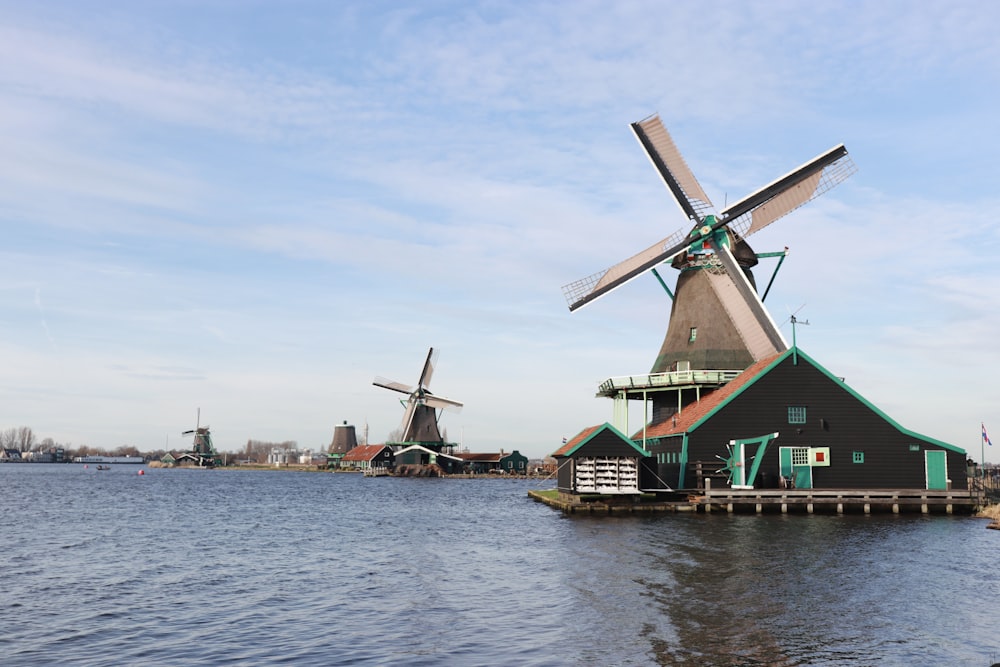 a building with windmills on the water