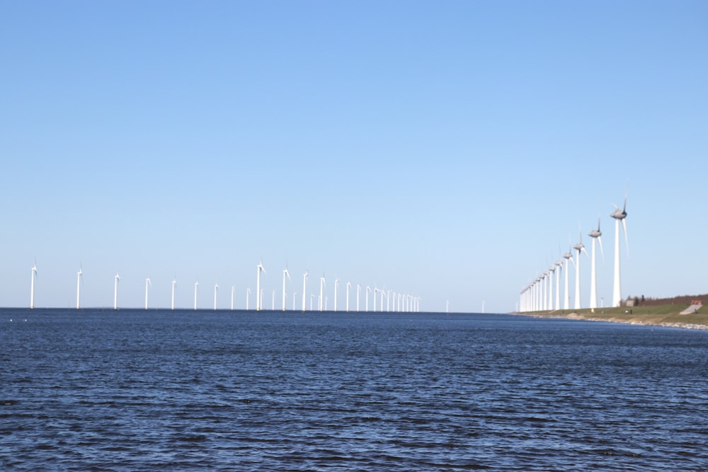 a group of wind turbines in the water