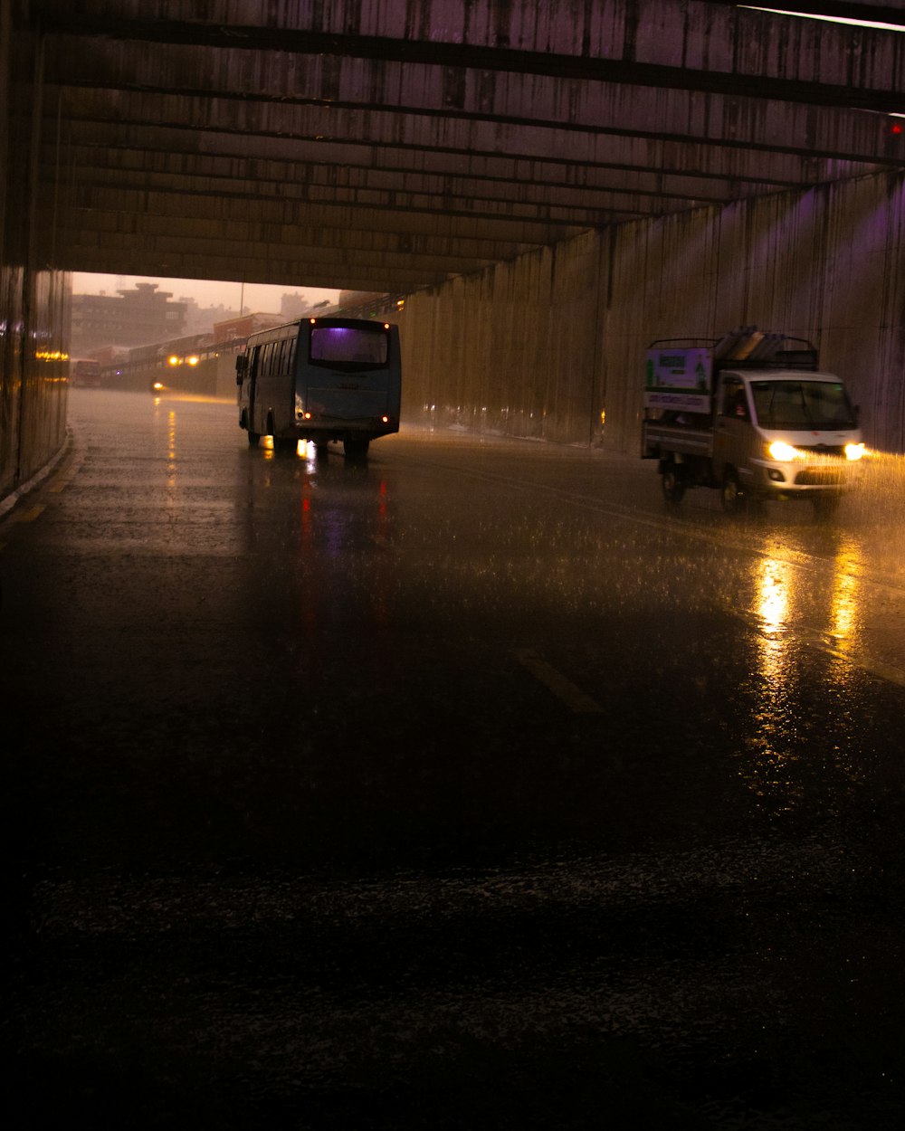 a couple of trucks on a road at night