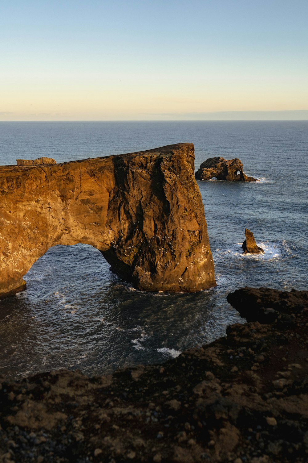 a cliff with a body of water below