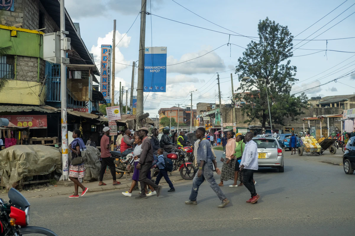A street in Nairobi in the early light, ordinary life moving through it.