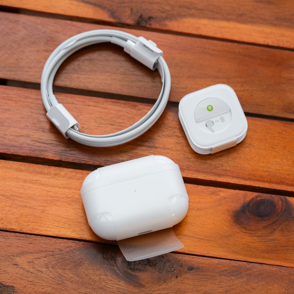 a pair of ear buds on a wooden surface